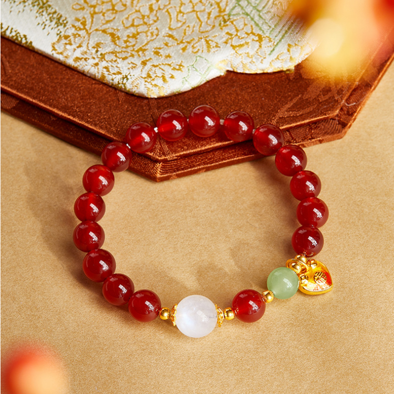 Top view of red agate heart bracelet with jade and moonstone beads