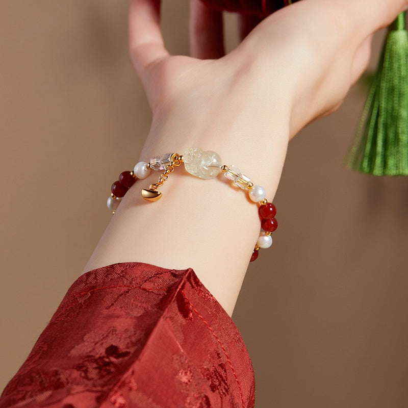Original supplier wrist photograph showing Pixiu and dangling ingot