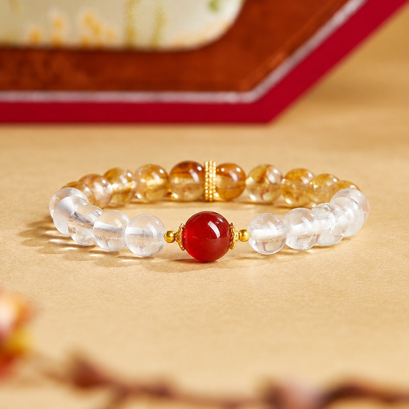 Red agate and clear quartz bracelet on a warm golden background