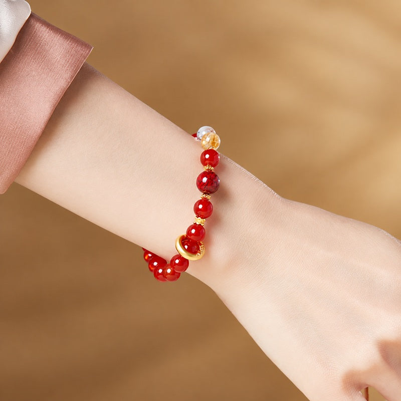 Original model wearing the red agate bracelet with silver circle detail