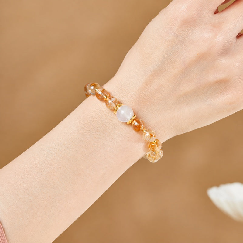 Blue moonstone and yellow quartz bracelet worn on a woman's wrist