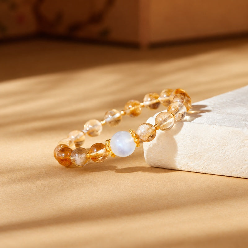 Blue moonstone focal bead and yellow quartz bracelet in side view