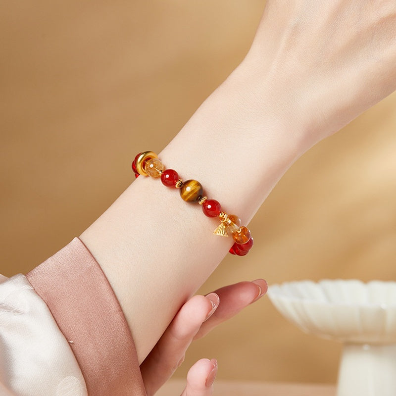 Red agate and tiger eye lotus bracelet worn on a wrist