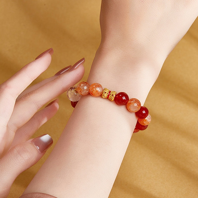 Red agate and dyed red inclusion quartz bracelet worn on the wrist