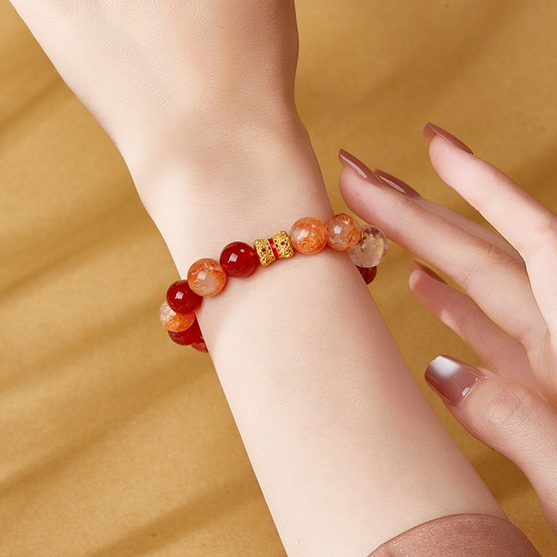 Alternate wrist view of red agate bracelet with gold tone focal bead