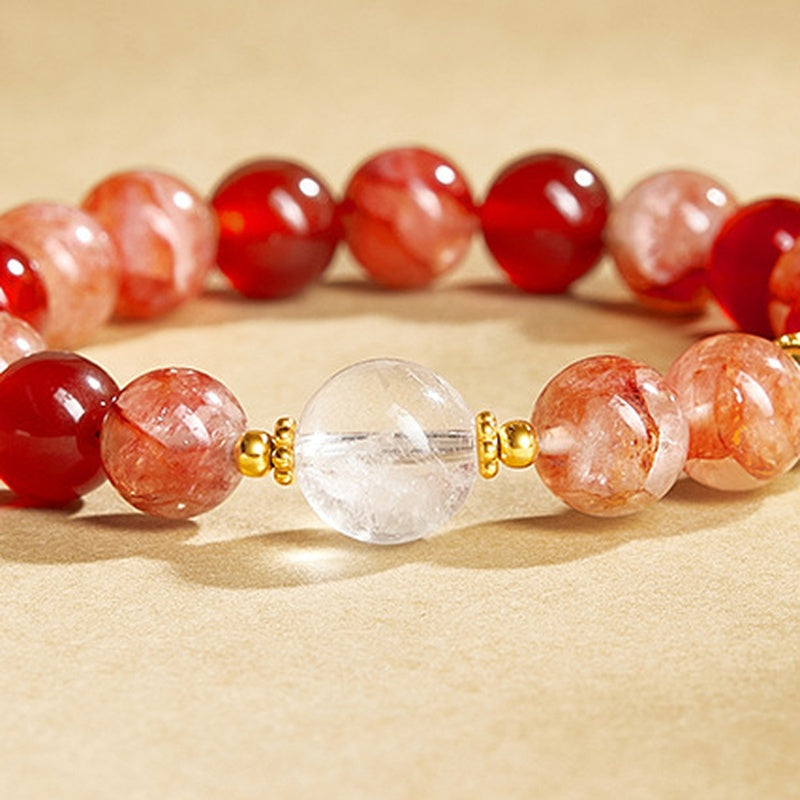 Clear quartz focal bead between red inclusion quartz bracelet beads