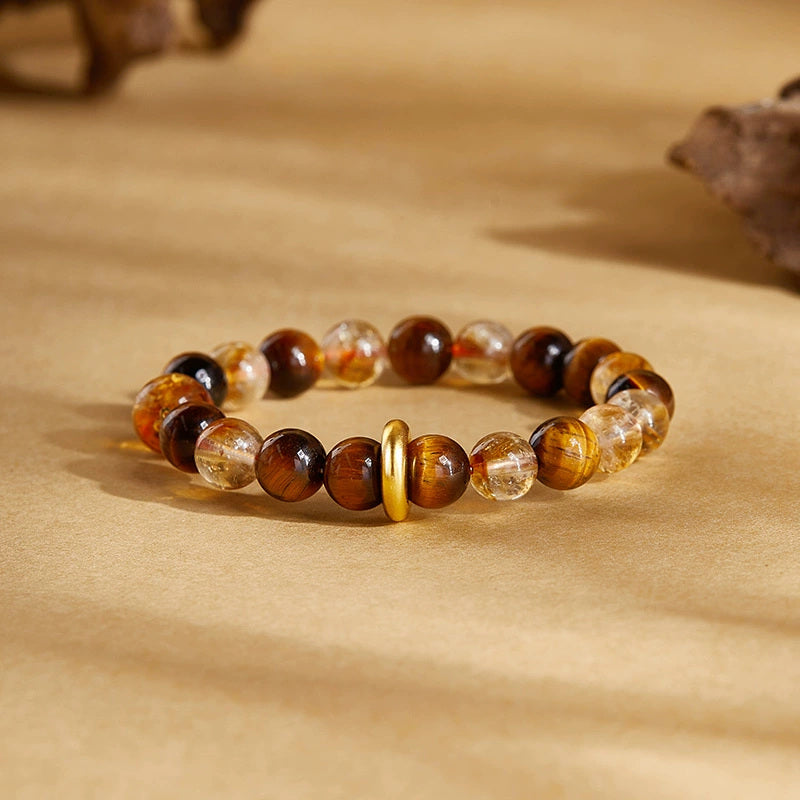 Front view of yellow quartz tiger's eye bracelet in amber light