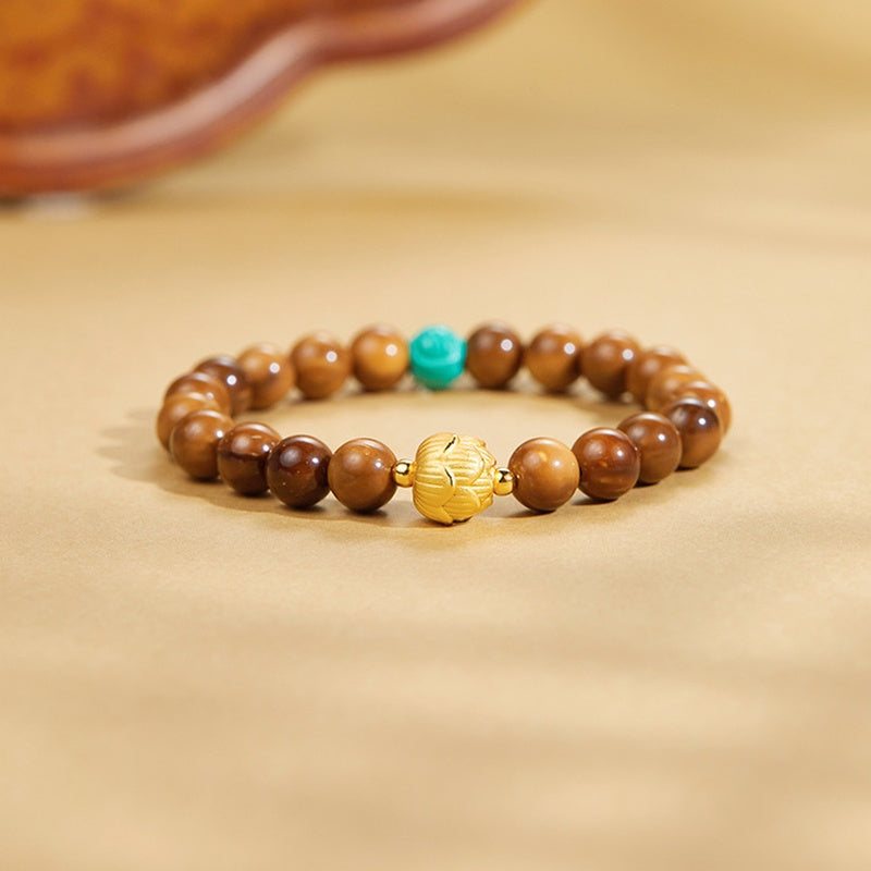 Kuka lotus bracelet on a warm golden background, low front view