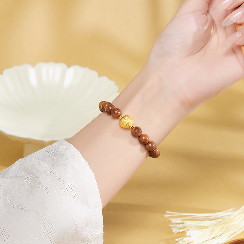 Original model wearing the bracelet against a warm background