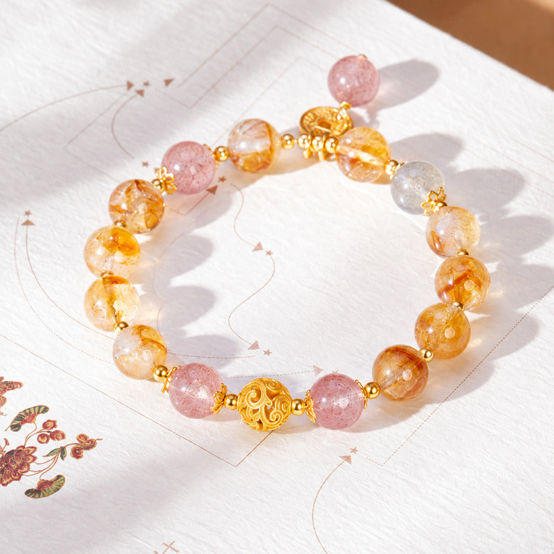 Overhead bracelet photograph showing pink beads and gray moonstone accent
