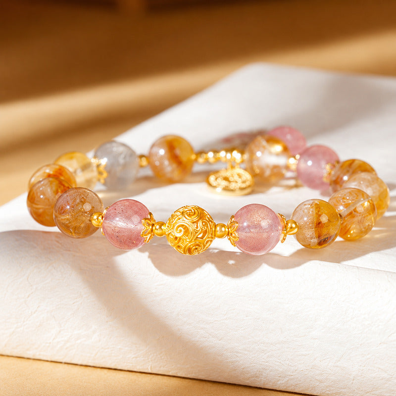 Front detail of filigree silver bead beside pink strawberry quartz