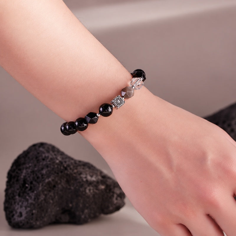 Wrist view showing the silver Bagua spacer and clear quartz bead