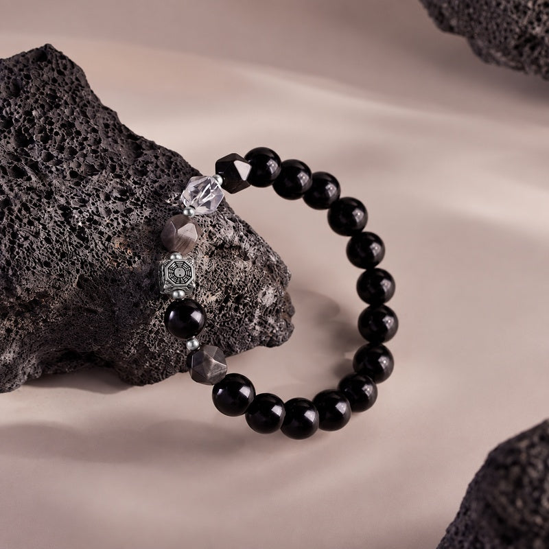 Full stretch bracelet leaning against rock with faceted gemstone accents