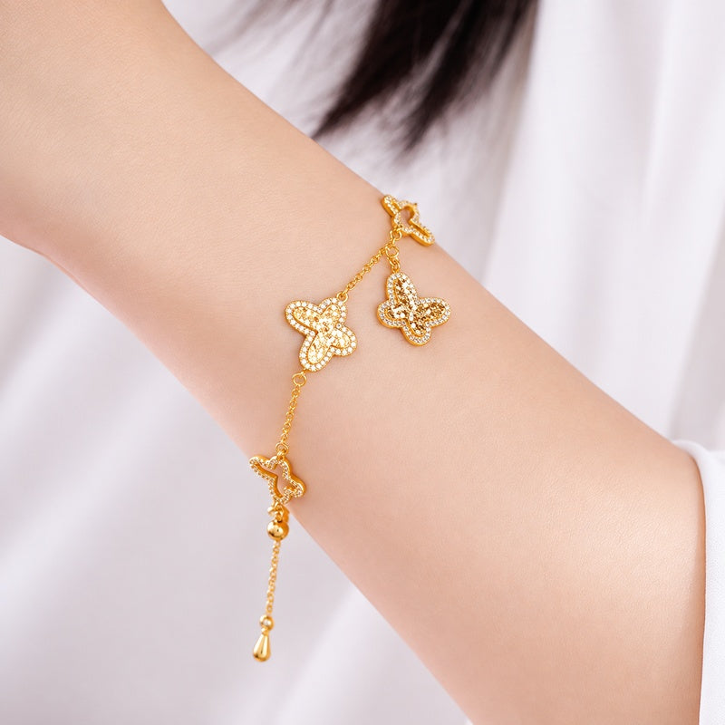 Supplier model wearing gold-tone butterfly bracelet