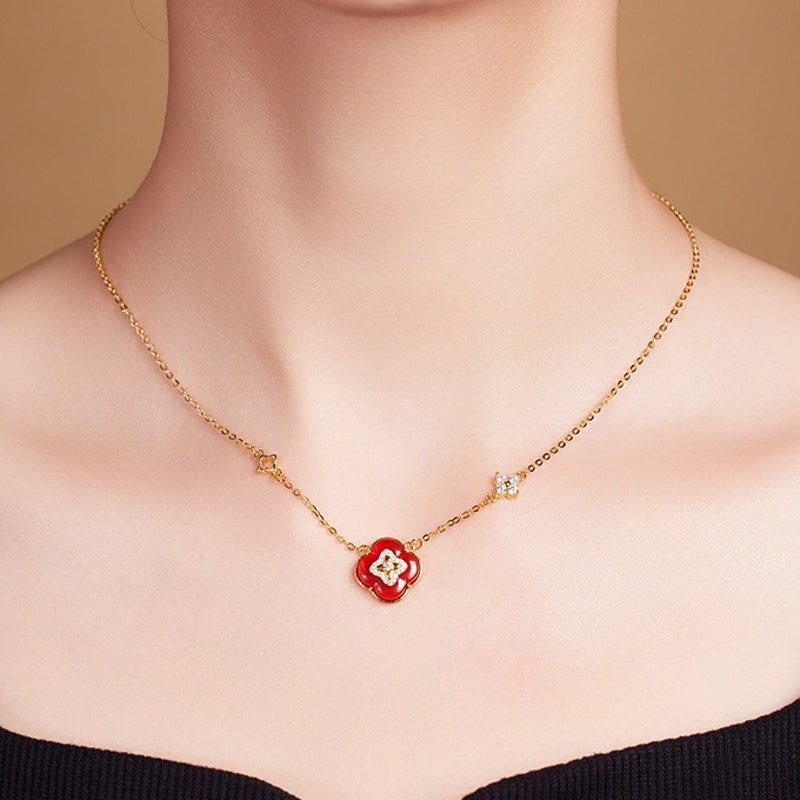Red agate clover necklace worn by the supplier model, front view