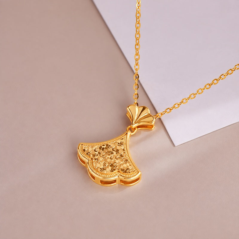 Oblique ginkgo pendant view showing textured leaf and polished upper fan