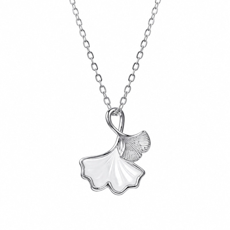 Ginkgo leaf necklace on white showing the pearly leaf, engraved silver leaf and fine oval-link chain