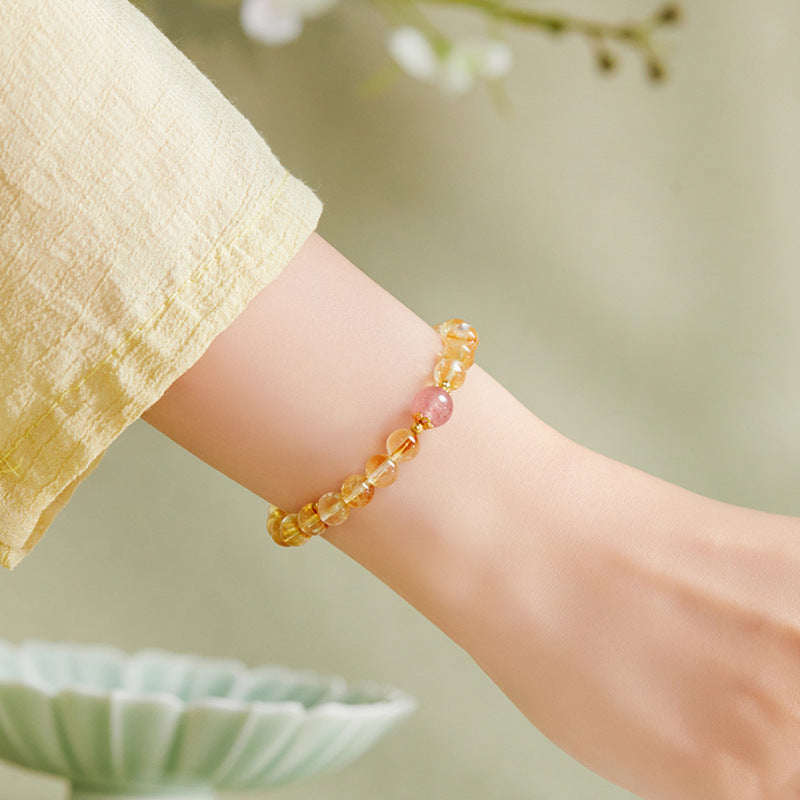 Side view of the supplier model wearing the yellow and pink crystal bracelet
