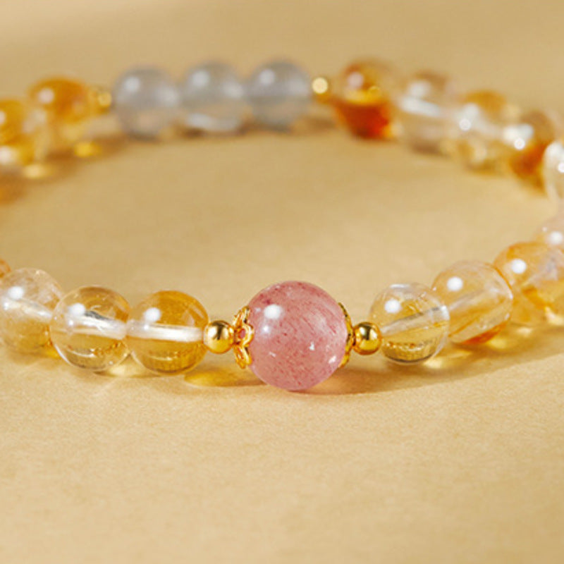 Close view of the pink strawberry crystal focal bead and translucent yellow tower quartz
