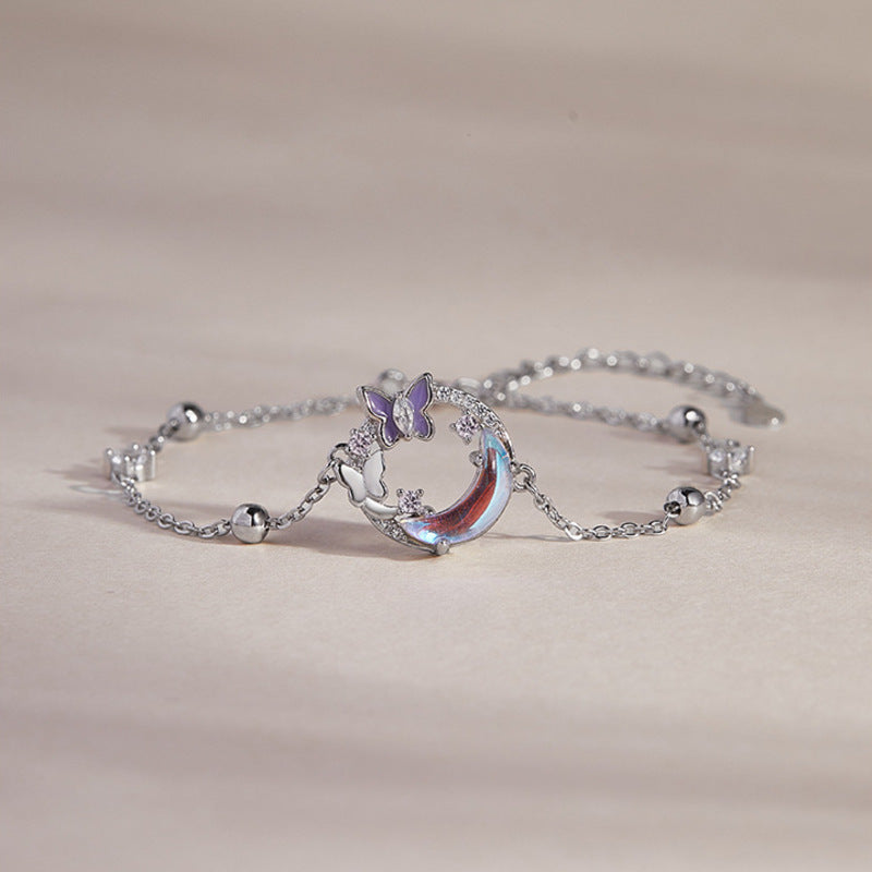 Butterfly moon silver bracelet on a warm beige background