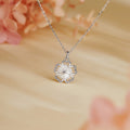 Mother-of-pearl cherry blossom necklace on a warm floral background