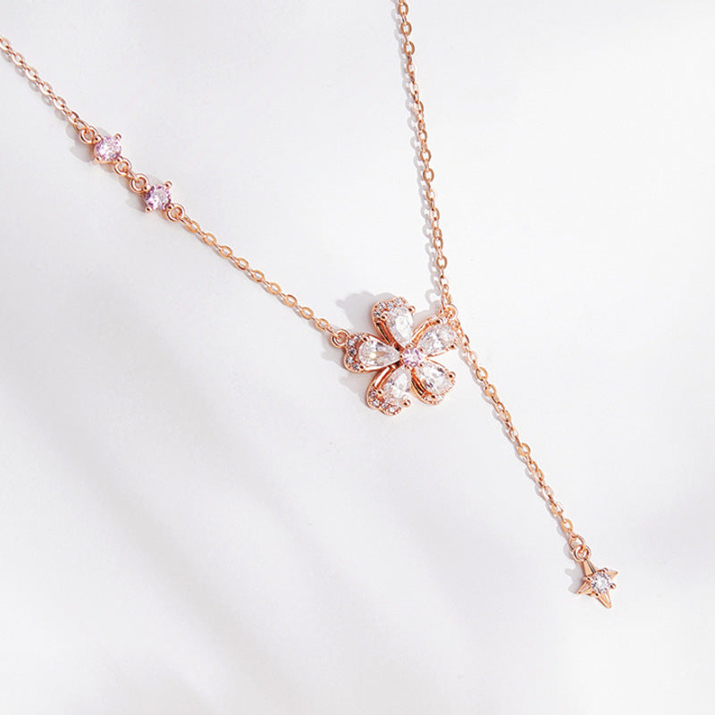 Peach blossom and star tassel necklace on a white background
