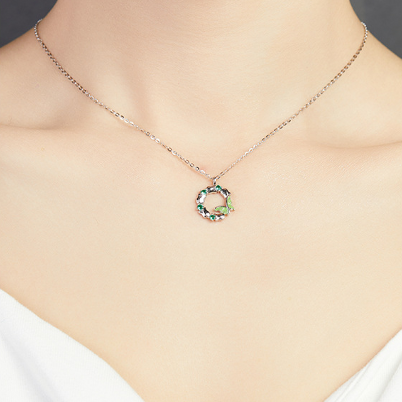 Supplier model wearing the green enamel butterfly wreath silver necklace