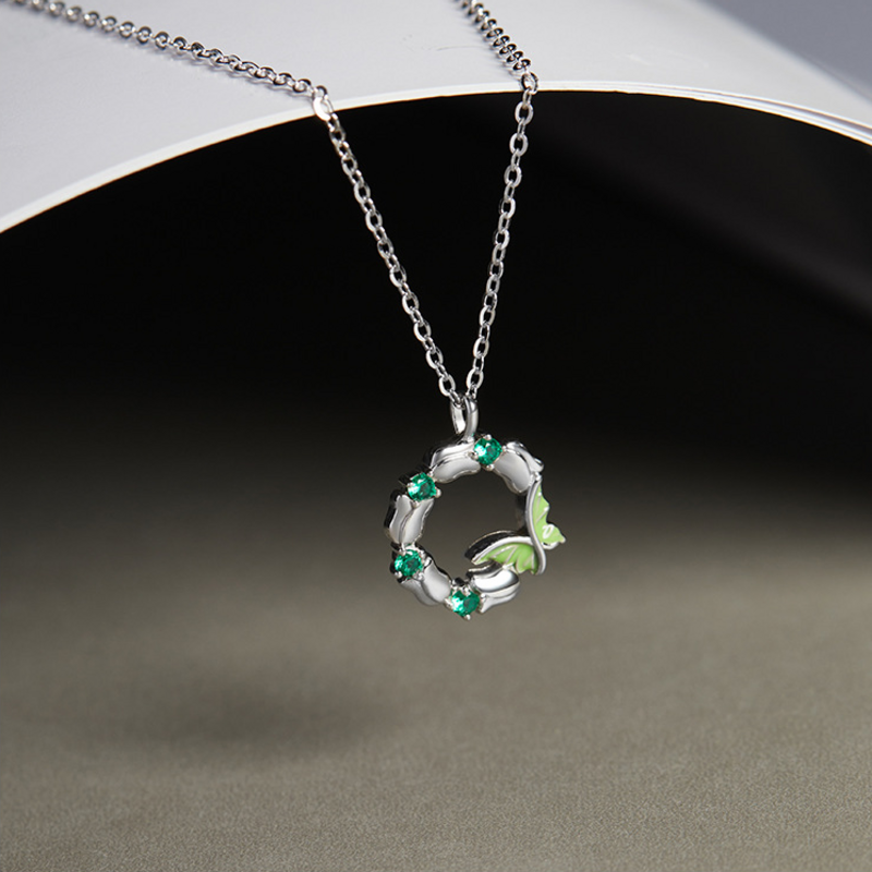 Suspended butterfly wreath necklace with polished silver petals