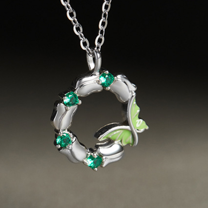 Oblique close-up of the butterfly wreath and green cubic zirconia