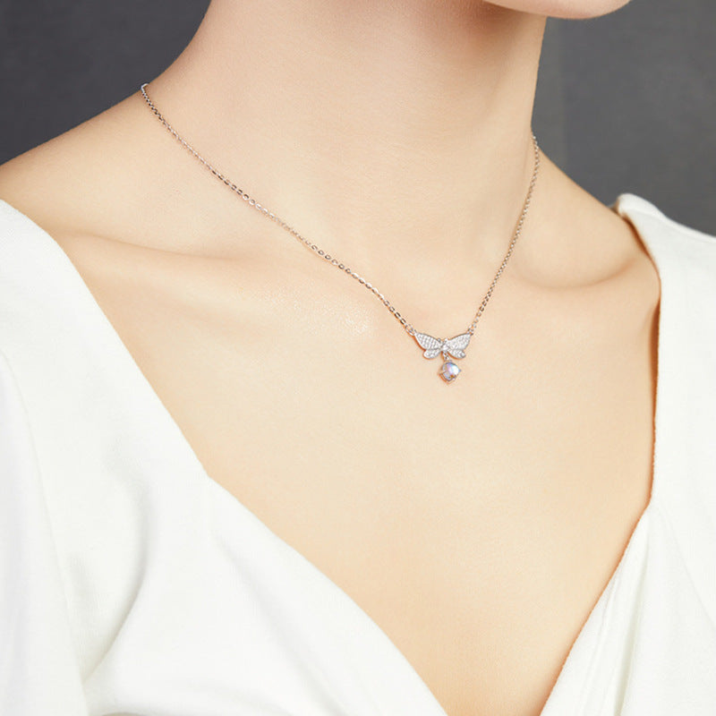 Original model wearing the dragonfly necklace, angled view
