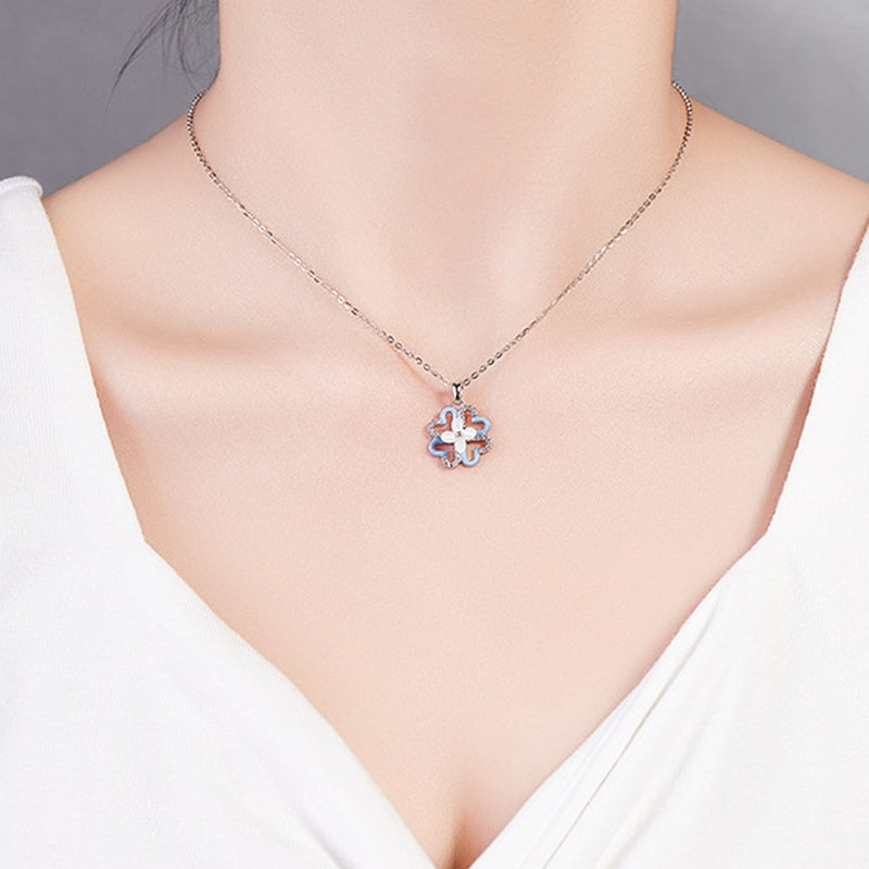 Original model wearing the blue clover necklace with a white blouse