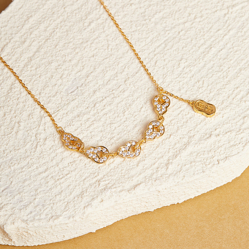 Angled view of five linked gourd motifs with cubic zirconia