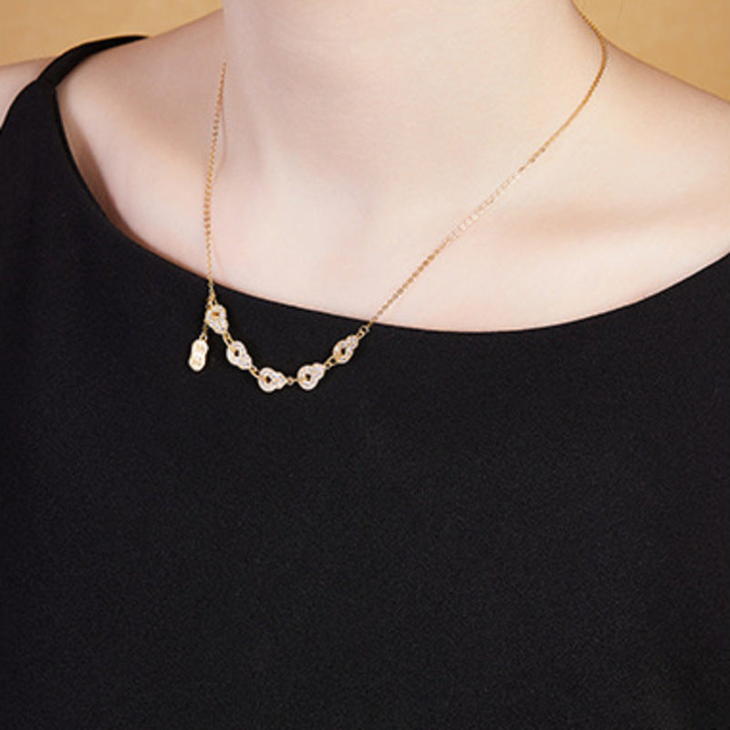 Side view of the original model wearing the gold-tone necklace