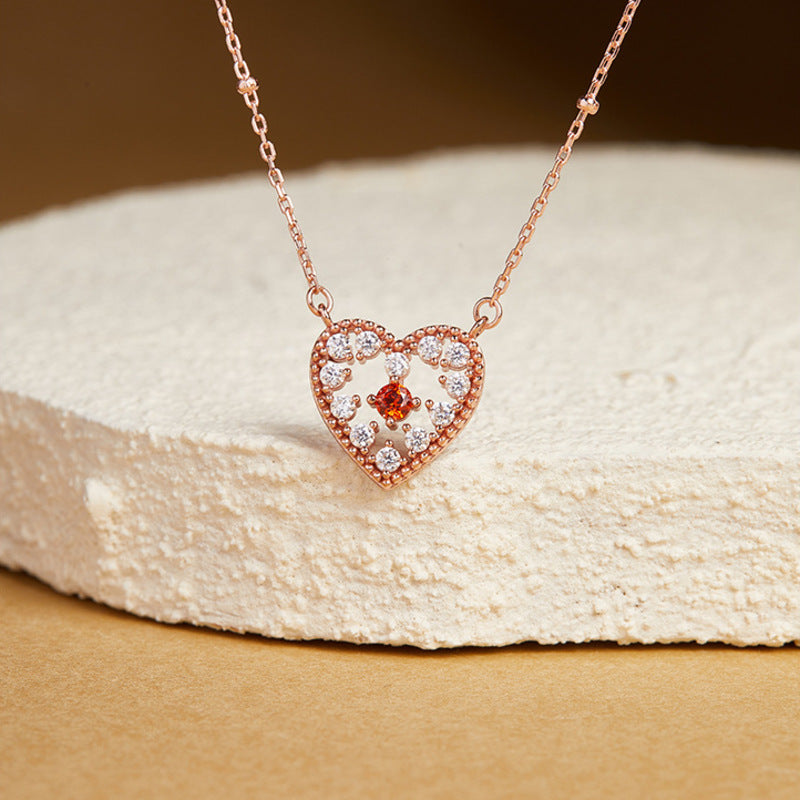 Heart necklace on a warm stone display