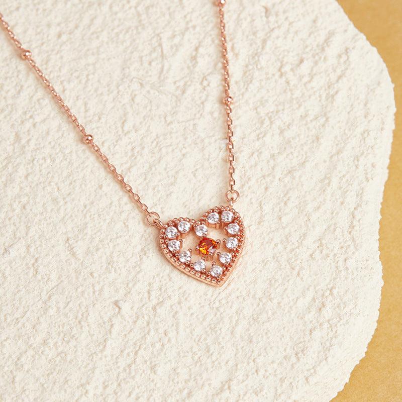 Heart necklace resting on textured stone