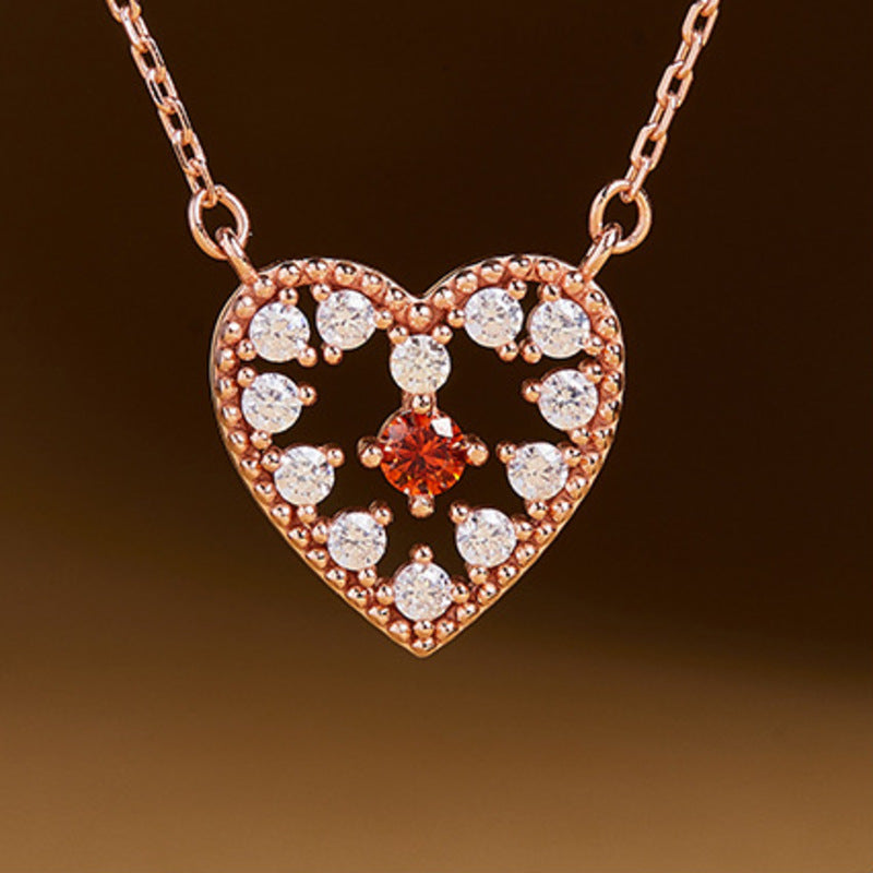 Front detail of the heart pendant and red cubic zirconia