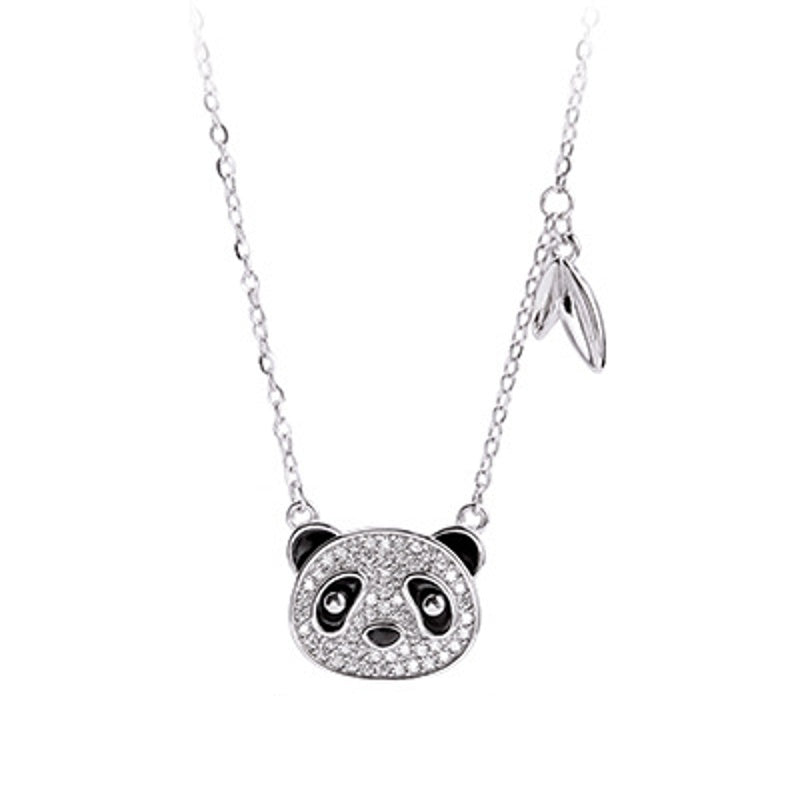 Panda pendant and leaf accent on a white background