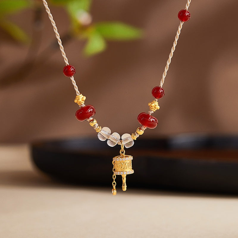 Red agate and clear quartz necklace against original warm background