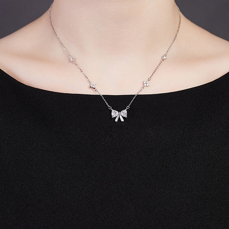 Original model wearing the silver bow necklace