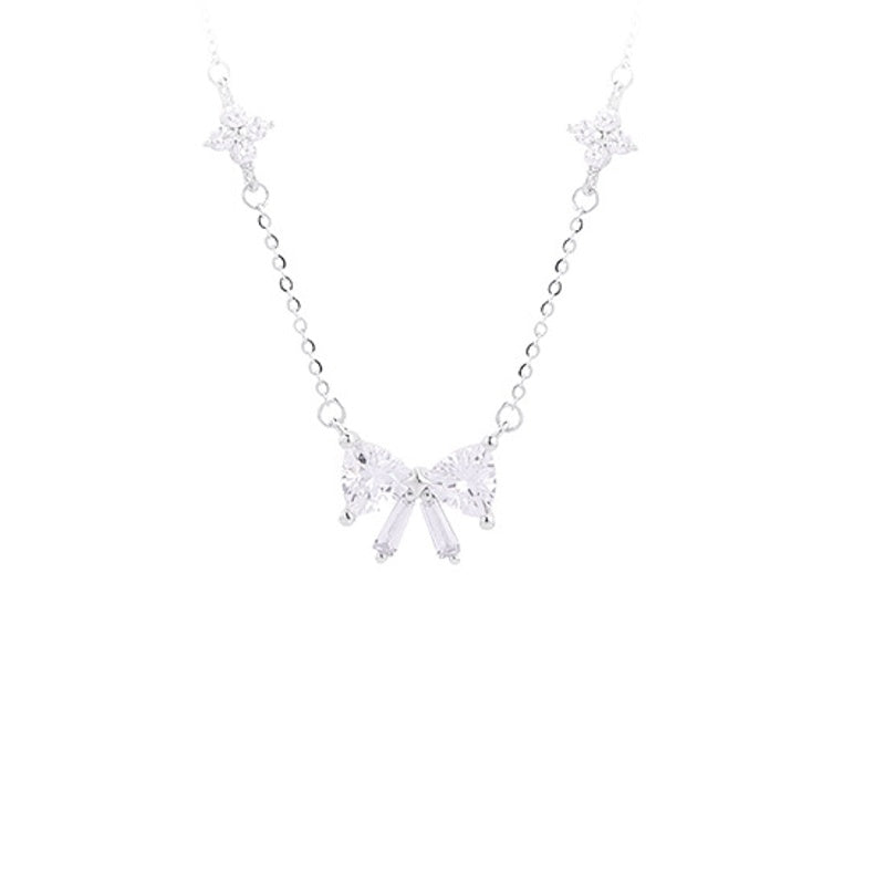 Silver bow necklace on a white background