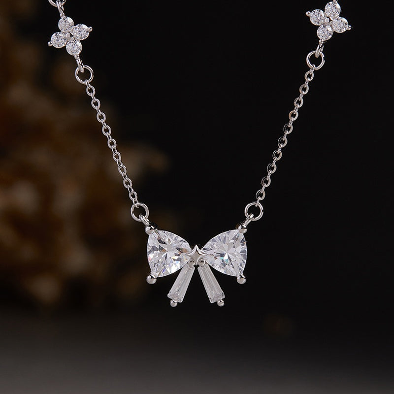 Front view of the faceted bow pendant and clover accents