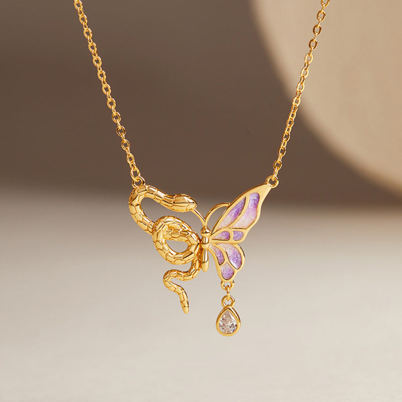 Snake and purple enamel butterfly necklace on original warm background