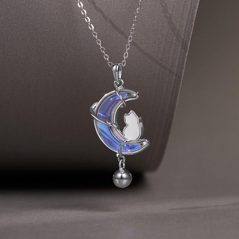 Blue iridescent cat moon necklace close-up