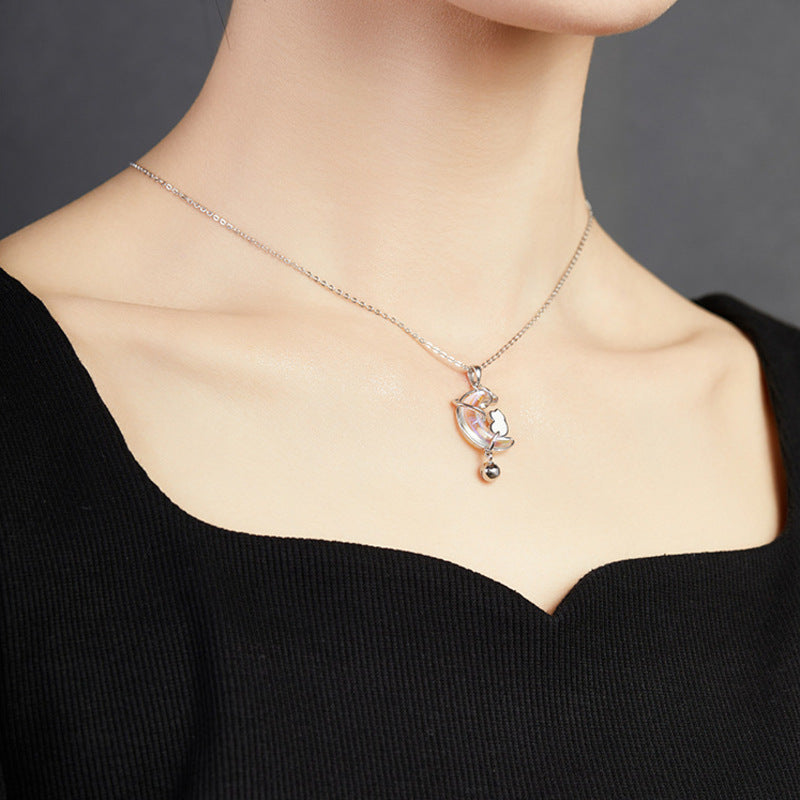 Model wearing the cat moon necklace from an angle