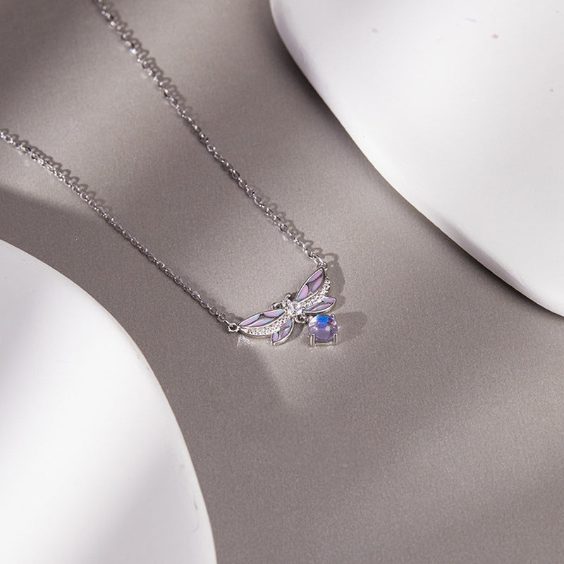Oblique view of the enamel butterfly necklace with iridescent glass drop