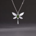 Nephrite jade and white mother-of-pearl dragonfly necklace on a clean dark gray background