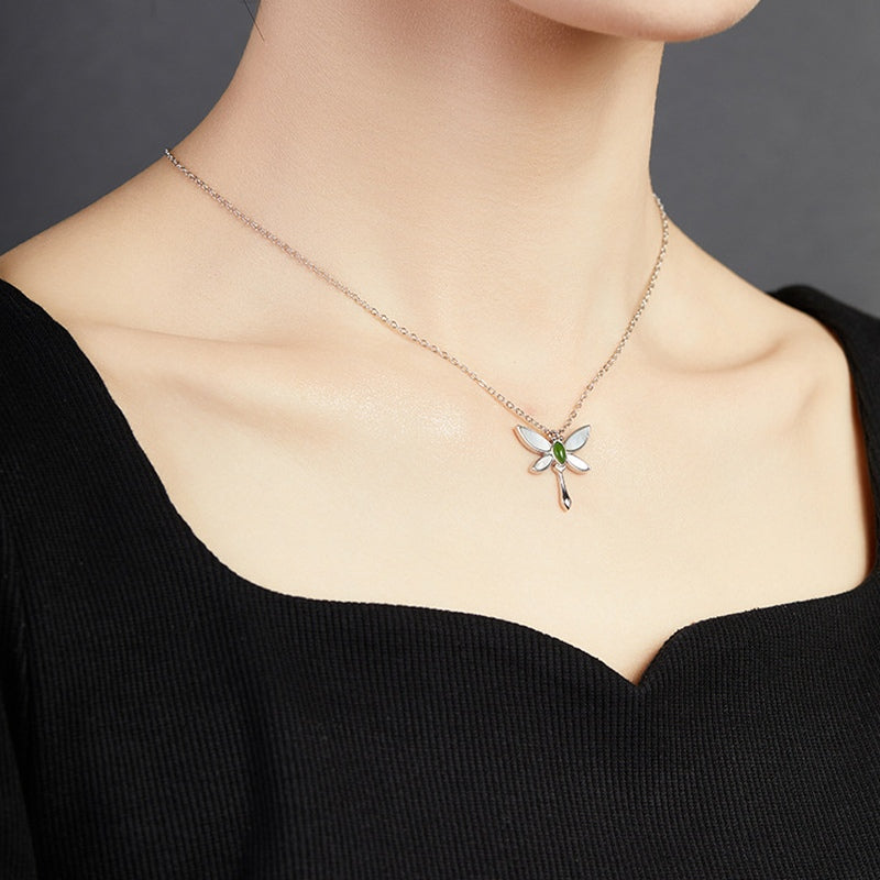 Original model wearing the dragonfly necklace at an angle