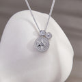 Star compass silver necklace resting on a white sculptural background