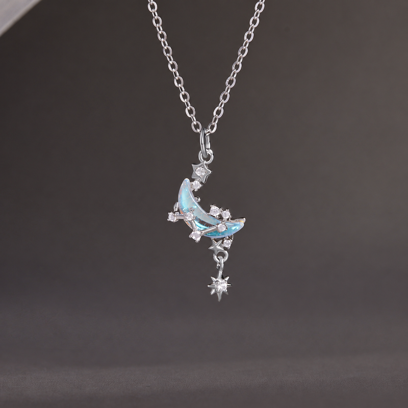 Star and moon silver necklace on its original grey background