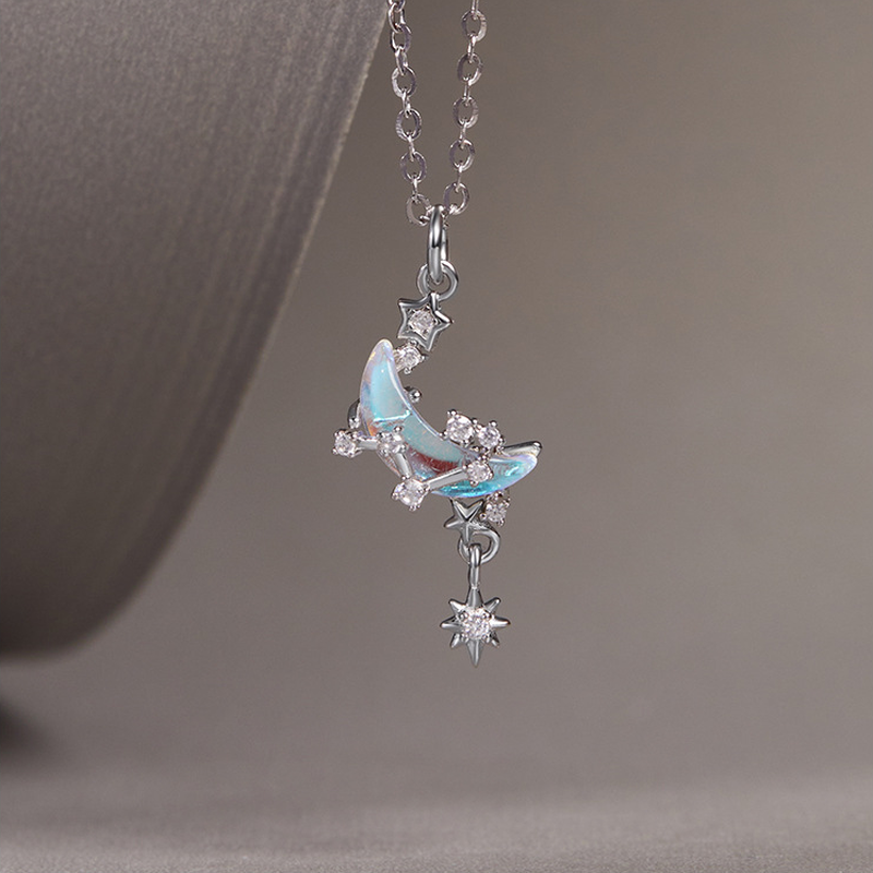 Suspended iridescent crescent and dangling star, side detail